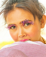 Image showing Happy Girl With Pink Eyelashes Biting Hat Shows Beauty