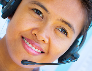 Image showing Smiling Helpdesk Operator Girl Shows Call Center Assistance