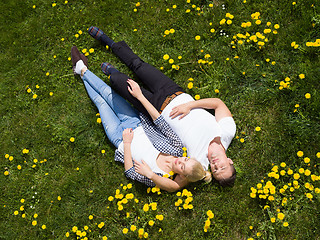 Image showing man and woman lying on the grass