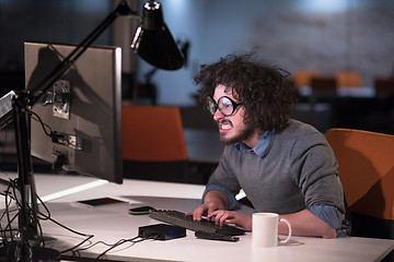 Image showing man working on computer in dark startup office