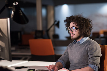 Image showing man working on computer in dark startup office