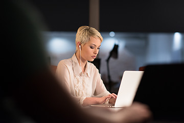 Image showing woman working on laptop in night startup office