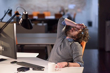 Image showing businessman relaxing at the desk