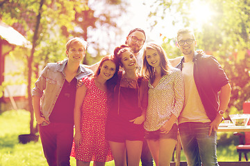 Image showing happy teenage friends hugging at summer garden