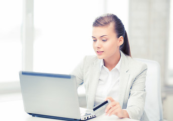 Image showing businesswoman with laptop using credit card