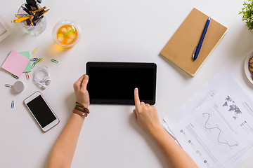 Image showing hands with tablet pc and notebook at office table