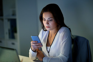 Image showing businesswoman with smartphone at office