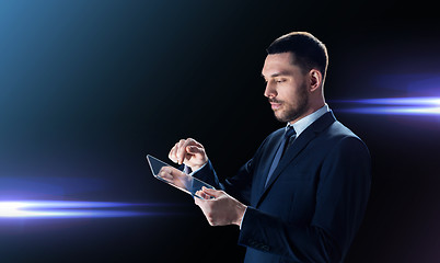 Image showing businessman in suit with transparent tablet pc