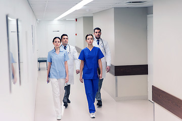 Image showing group of medics or doctors walking along hospital