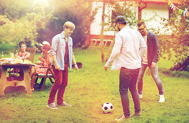 Image showing happy friends playing football at summer garden