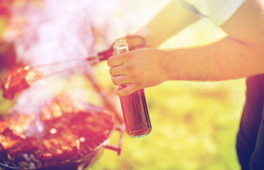 Image showing man cooking meat on barbecue grill at summer party