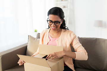 Image showing happy young indian woman with parcel box at home