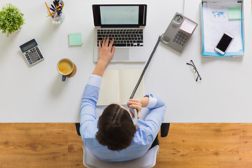 Image showing businesswoman calling on phone at office table