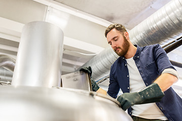 Image showing man working at craft brewery or beer plant