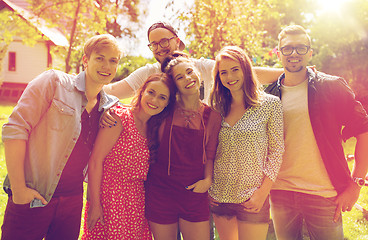 Image showing happy teenage friends hugging at summer garden