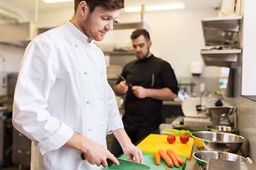 Image showing chef and cook cooking food at restaurant kitchen