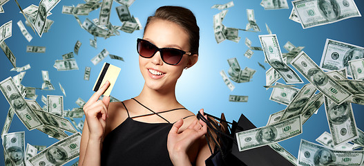 Image showing happy woman with credit card and shopping bags