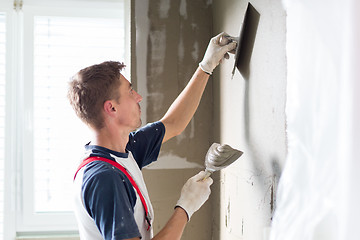 Image showing Plasterer renovating indoor walls and ceilings.