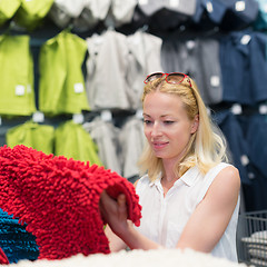 Image showing Woman choosing the right item for her apartment in a modern home furnishings store.