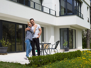 Image showing couple hugging in front of  new luxury home