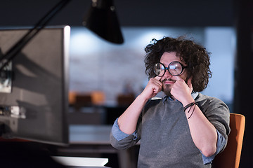 Image showing man working on computer in dark startup office