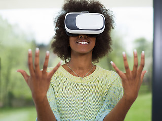 Image showing black woman using VR headset glasses of virtual reality