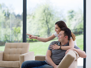 Image showing young handsome couple hugging on the sofa