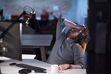 Image showing businessman relaxing at the desk