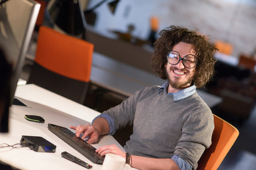 Image showing man working on computer in dark startup office