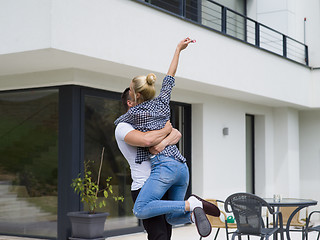 Image showing couple hugging in front of  new luxury home