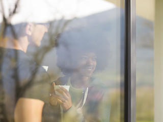 Image showing happy multiethnic couple relaxing at modern home indoors