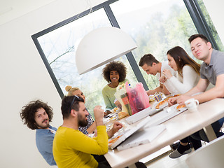 Image showing multiethnic group of happy friends lunch time