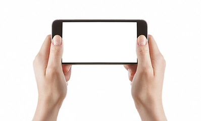 Image showing Young girl hands holding black smart phone on white 