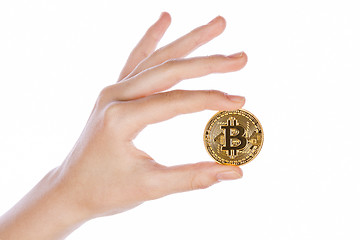 Image showing Young girl hand holding bitcoin on white 