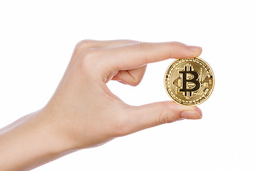 Image showing Young girl hand holding bitcoin on white 