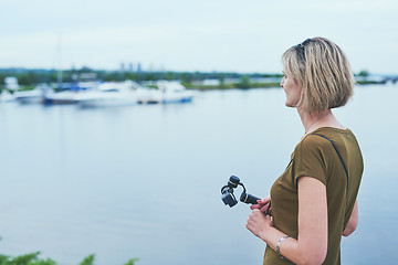 Image showing Woman capturing herself with personal camera