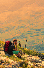 Image showing Hiker Resting on Rocks in Mountains