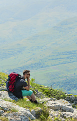 Image showing Hiker Resting on Rocks in Mountains