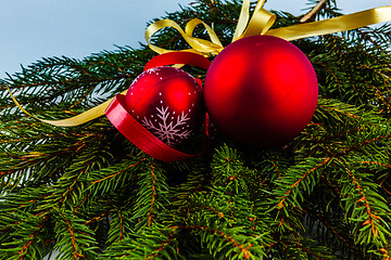 Image showing Christmas decorations with red balls and gold ribbons.