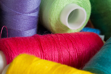 Image showing Pile of coloured bobbins of thread