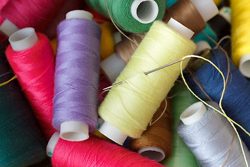 Image showing Pile of coloured bobbins of thread