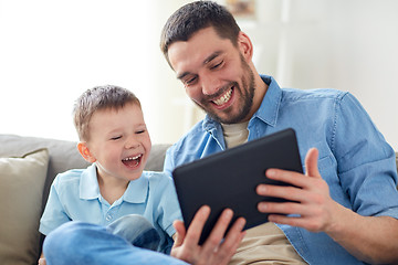 Image showing father and son with tablet pc playing at home