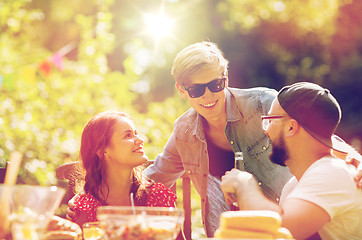 Image showing happy friends having dinner at summer garden party