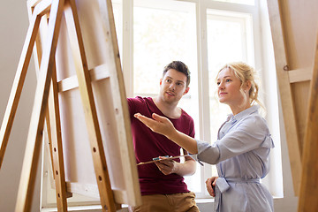 Image showing artists with palette and easel at art school