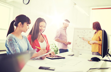 Image showing happy creative team with tablet pc at office