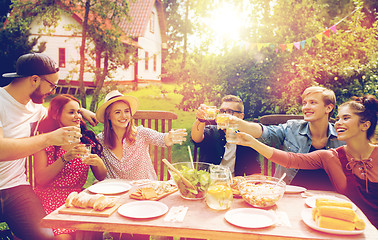 Image showing happy friends having party at summer garden