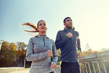 Image showing happy couple running outdoors