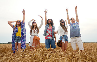 Image showing happy young hippie friends dancing on cereal field