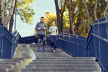 Image showing happy couple running downstairs in city