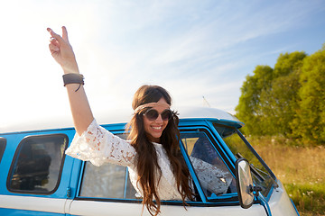 Image showing happy hippie woman showing peace in minivan car